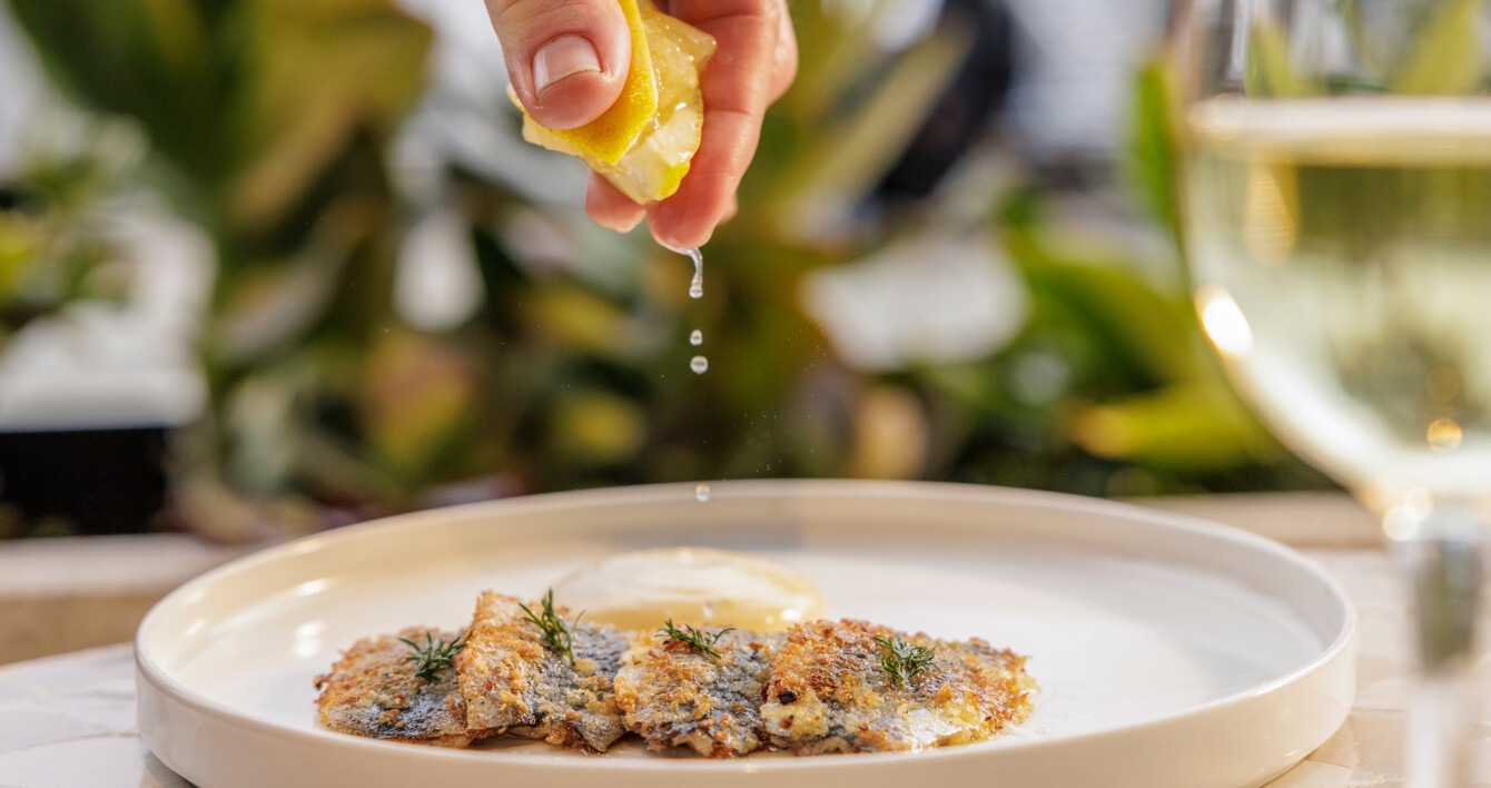 Georges drizzling lemon over food